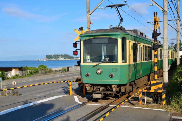 Enoden Train with Enoshima in the background.