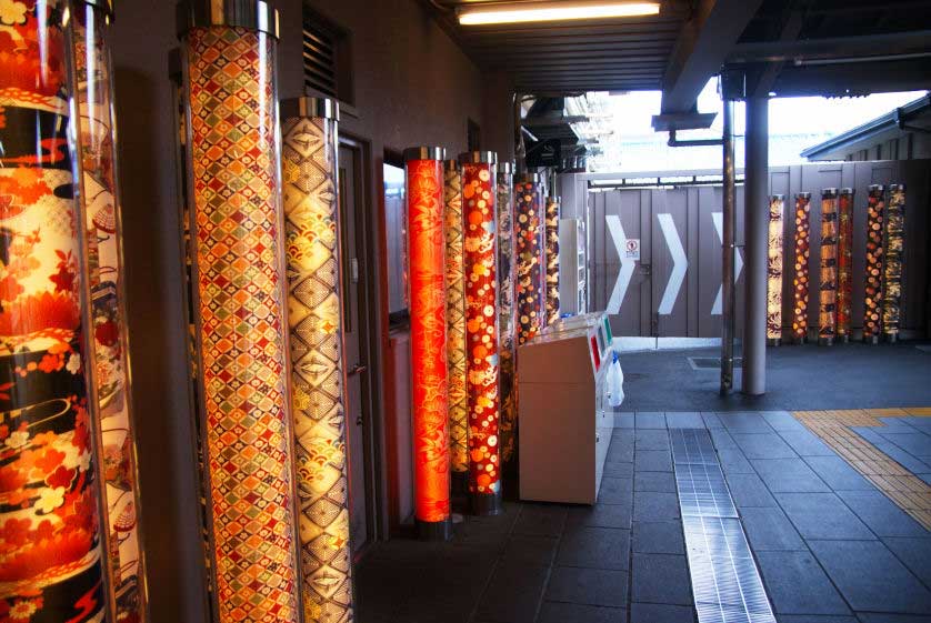 Inside Arashiyama Randen Station the kimono pillars are illuminated.