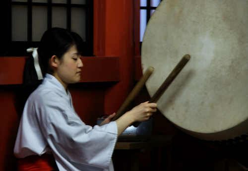 Miko playing a taiko in a ceremony at the Toshogu Shrine in Hiroshima.