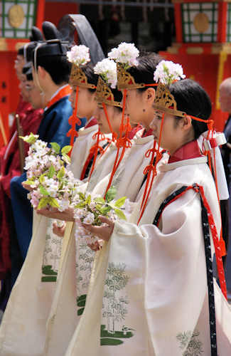 A group of Miko in ceremonial dress at a major festival.