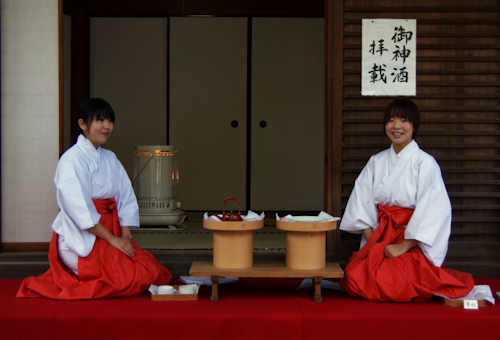 A pair of Miko serving Omiki, sacred sake, during the New Year at a shrine in Kyoto.