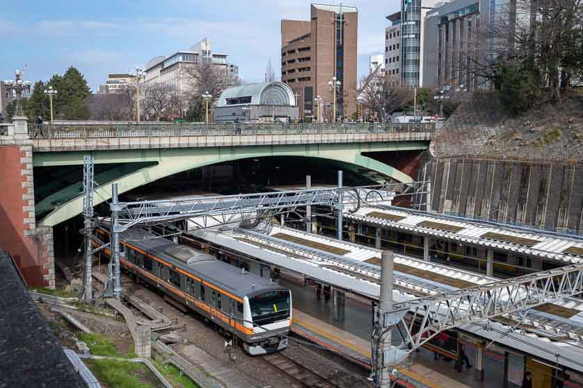 Yotsuya-mitsume Bridge (part of Shinjuku-dori Avenue) over Yotsuya Station, with Kojimachi Exit on far side of road.