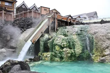 Water pouring into a outdoor cooling pool in Kasatsu Onsen