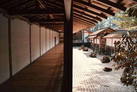 Brown wooden flooring beside wall and zen garden in Koyasan