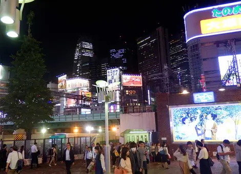 Nightly Shinjuku cityscape seen from outside the main entrance of Seibu Shinjuku Station, Tokyo
