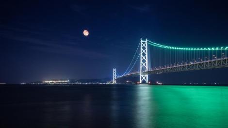 The lights at night on the Akashi Kaikyo Bridge.