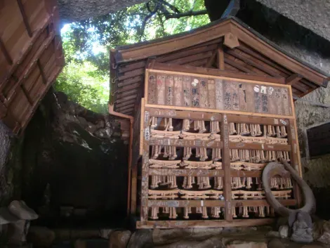 Al interior de la cueva, los símbolos budistas y shinto se entremezclan alrededor de esta fuente. 