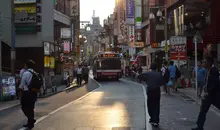 Bus in the middle of a small busy street in Tokyo