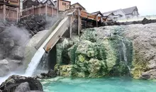 Water pouring into a outdoor cooling pool in Kasatsu Onsen