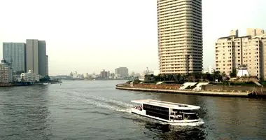 A barge Yakatabune between the buildings of Tokyo Bay.
