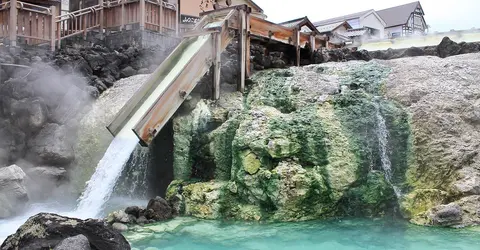 Water pouring into a outdoor cooling pool in Kasatsu Onsen