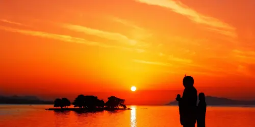 Sunset over Lake Shinji and its small island sanctuary, in Japan